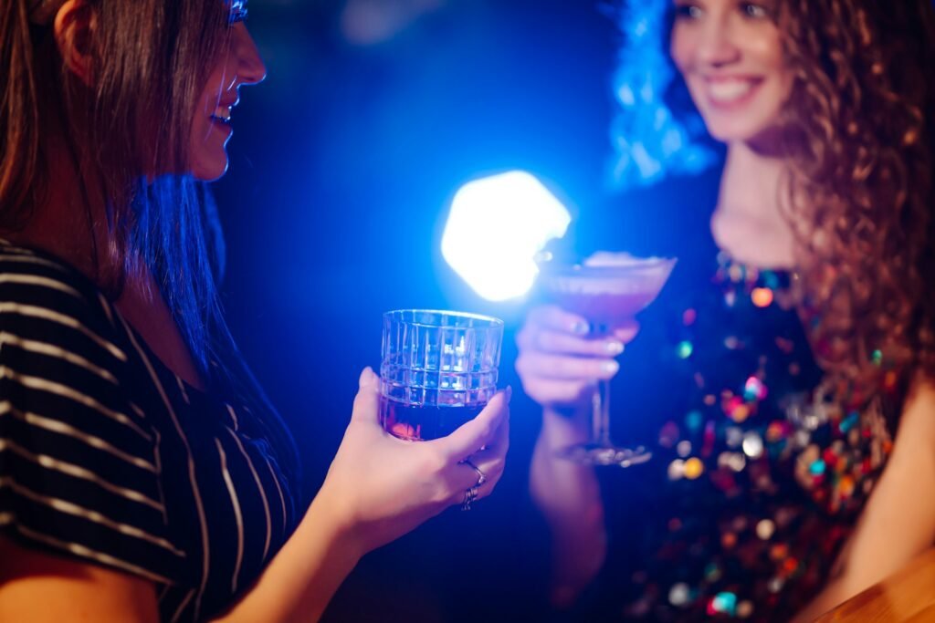 Coctails party. ?ocktail in the hands of a woman. Young woman drinking cocktails in bar.
