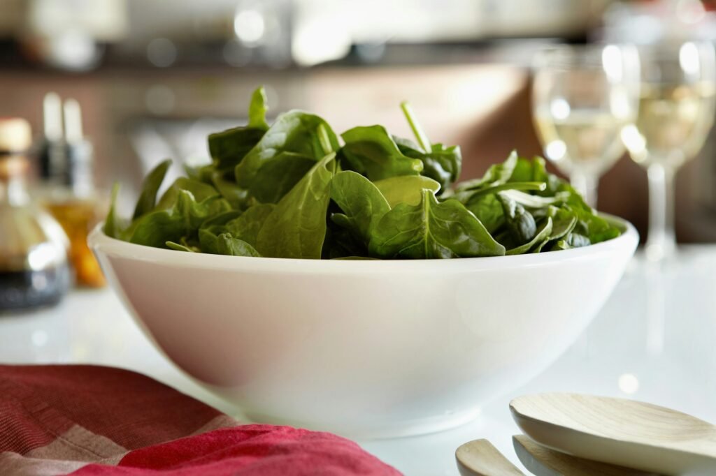 Bowl of spinach salad on kitchen table