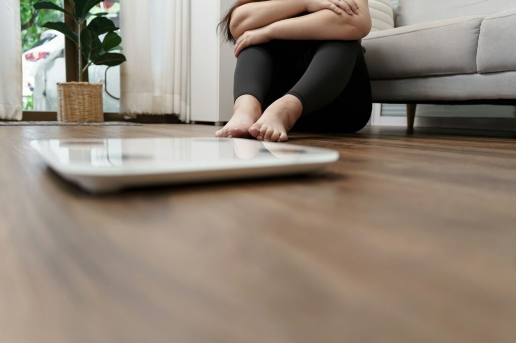 Sad woman with fat upset bored of dieting Weight loss fail  Fat diet and scale sad asian woman