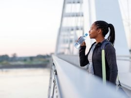Woman drinking water after morning workout session