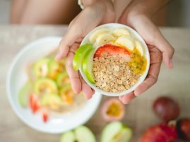 young Asian woman girl holding health food fresh vegetable in lifestyle at home